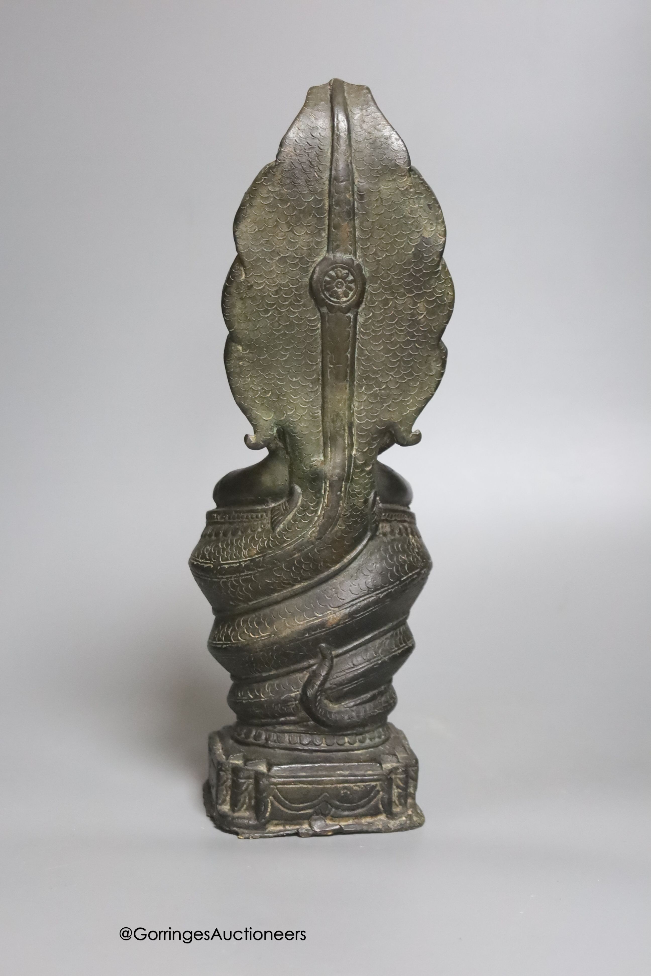 An 18th/19th century Cambodian bronze seated figure of Buddha Shakyamuni and the cobra Mucalinda 33cm